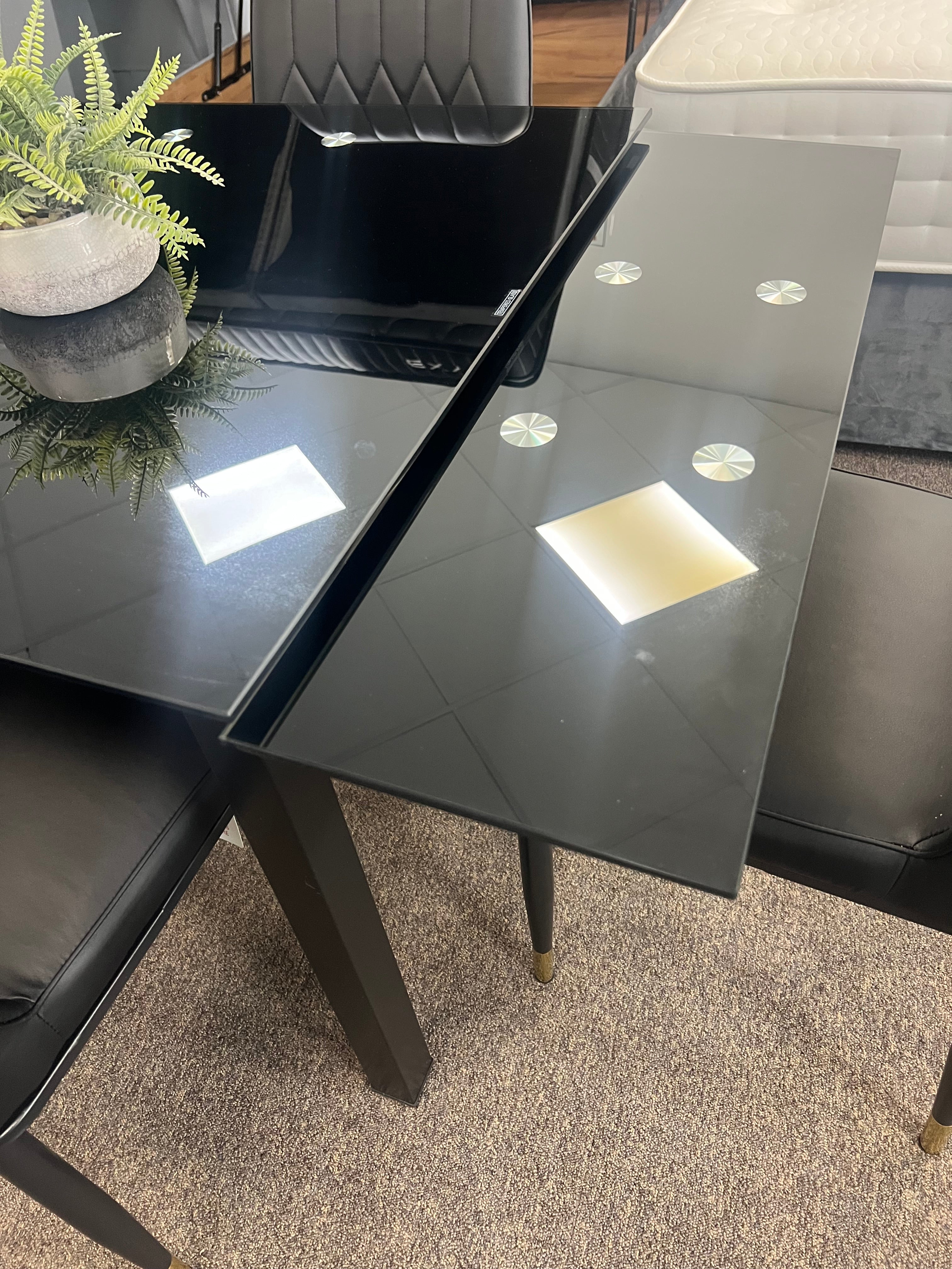 Glass extendable dining table with four chairs