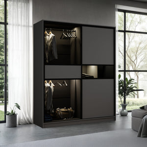 Modern wardrobe with clothes and bags in a room with large windows and plants.